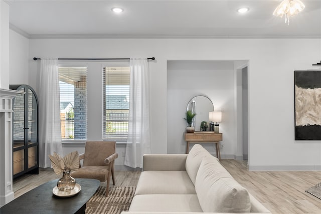 living room with light wood-type flooring and ornamental molding