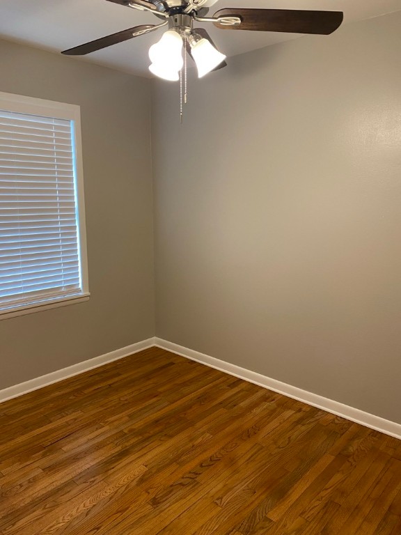 unfurnished room featuring ceiling fan and dark hardwood / wood-style floors