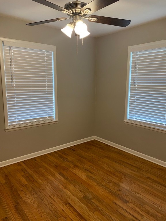 spare room featuring ceiling fan and dark hardwood / wood-style flooring