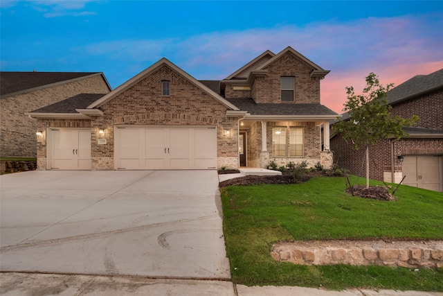 craftsman inspired home featuring a lawn and a garage