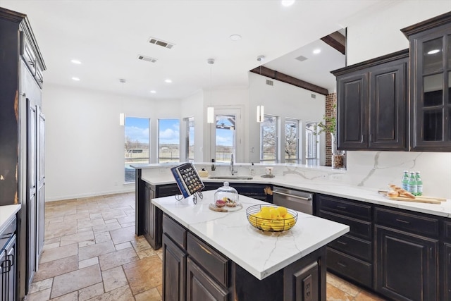 kitchen with a kitchen island, plenty of natural light, and dishwasher