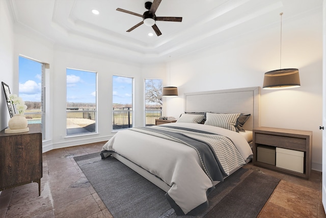 bedroom featuring ceiling fan and a tray ceiling