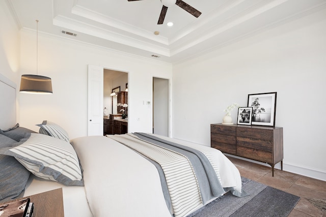 bedroom with crown molding, ceiling fan, and a tray ceiling