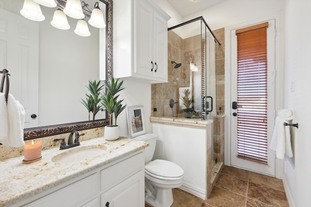 bathroom with toilet, an enclosed shower, and vanity