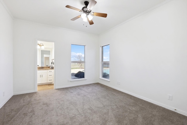 unfurnished bedroom featuring ceiling fan, connected bathroom, light carpet, and ornamental molding