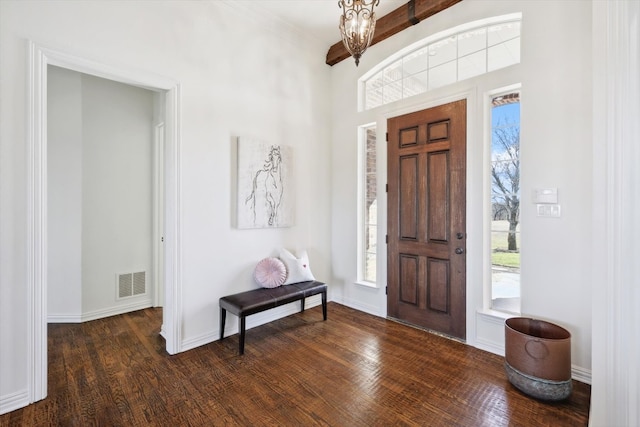 entryway with beam ceiling and dark hardwood / wood-style flooring