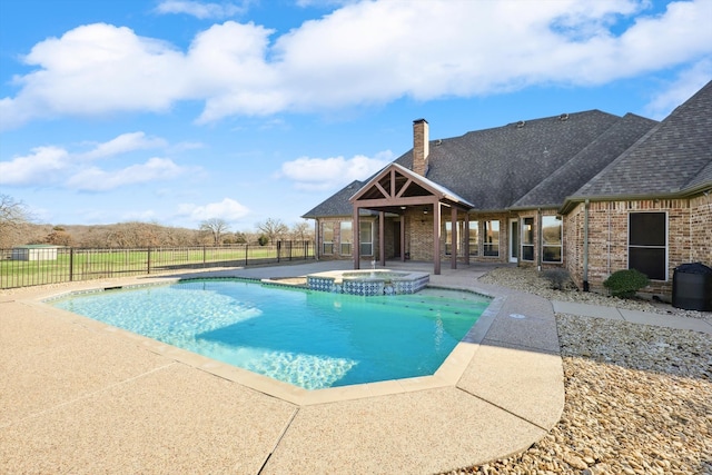 view of swimming pool featuring an in ground hot tub and a patio area