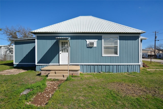 rear view of house featuring a yard