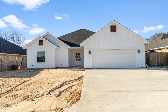 modern farmhouse featuring central air condition unit and a garage