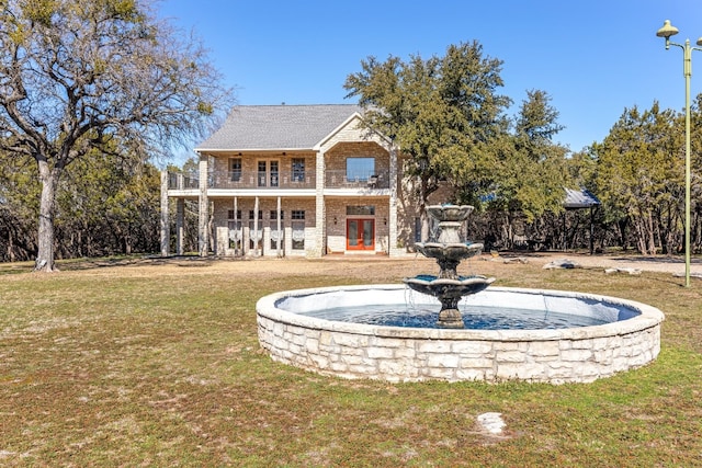 view of front of property with a front lawn and a balcony