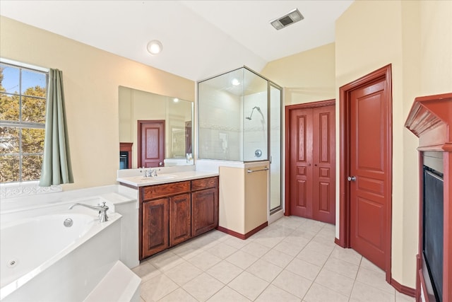 bathroom with oversized vanity, tile floors, and separate shower and tub