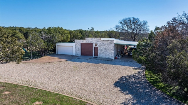 view of front of house with a carport and a garage