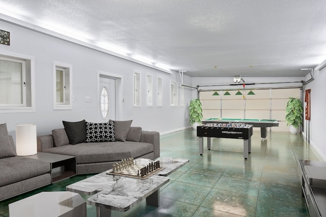 recreation room with tile floors, pool table, and a textured ceiling