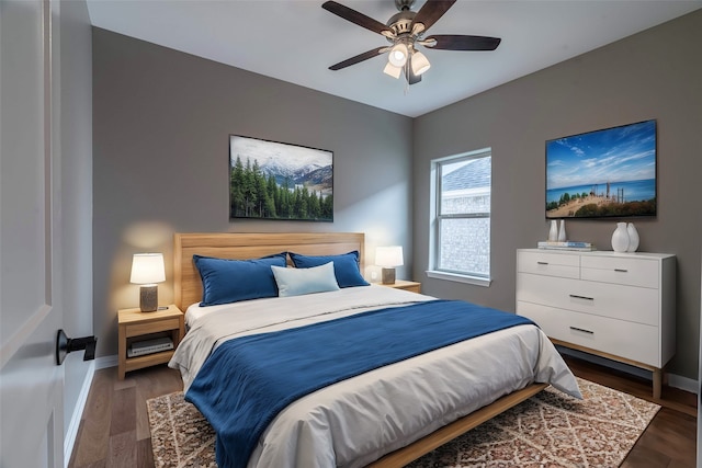 bedroom featuring a ceiling fan, baseboards, and wood finished floors