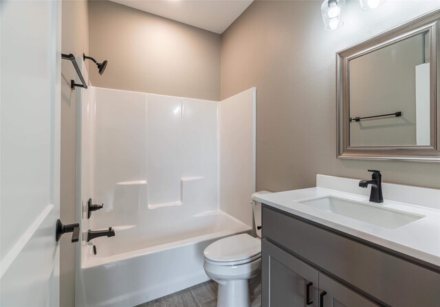 bathroom featuring  shower combination, vanity, and toilet