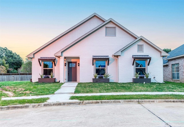 view of front of house with a yard