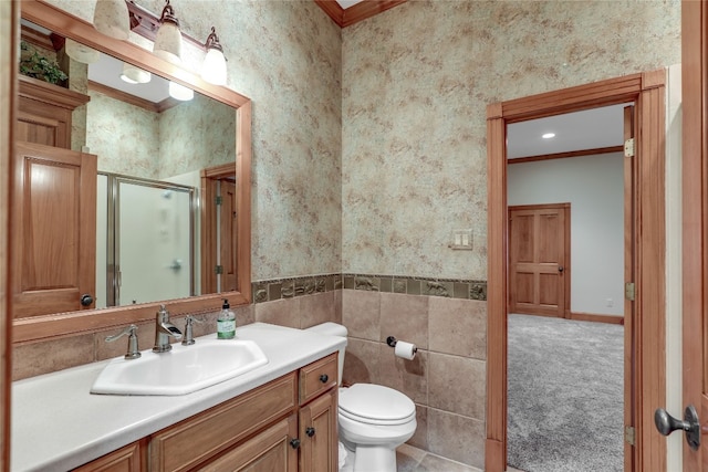 bathroom featuring oversized vanity, crown molding, toilet, and tile walls