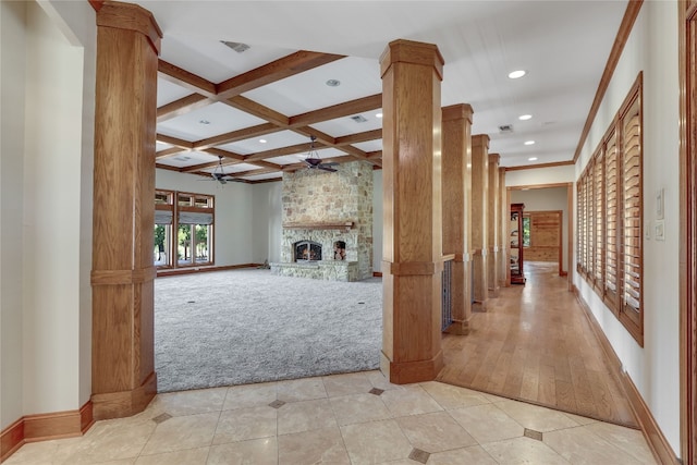 interior space featuring coffered ceiling, decorative columns, beamed ceiling, light hardwood / wood-style flooring, and crown molding