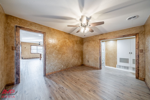 empty room featuring ceiling fan and light hardwood / wood-style flooring