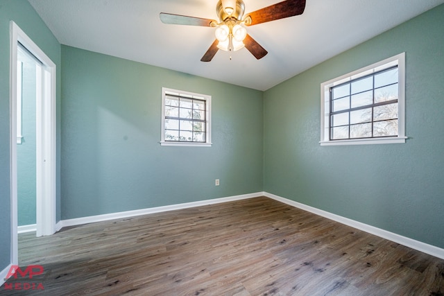 empty room with ceiling fan and hardwood / wood-style floors