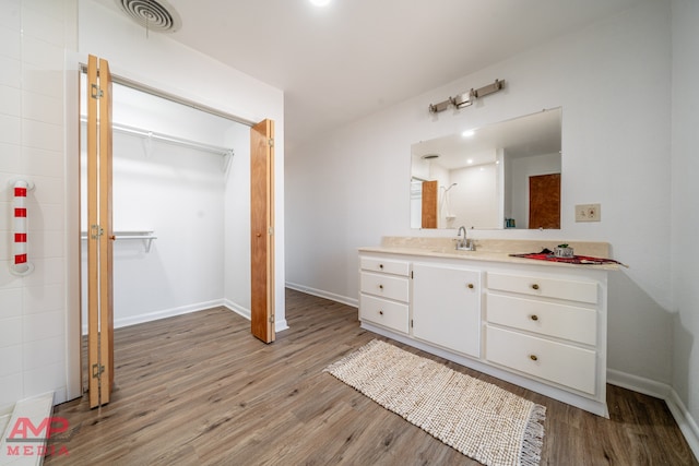 bathroom with vanity and wood-type flooring