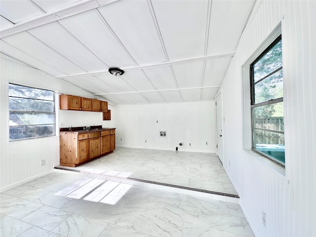 interior space featuring light tile floors and lofted ceiling