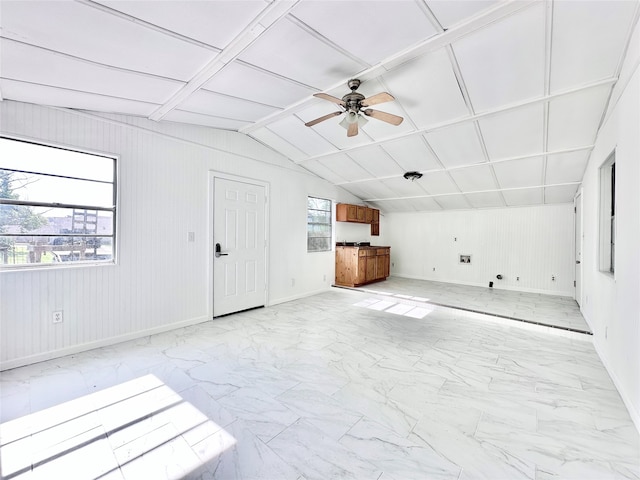 unfurnished living room with lofted ceiling, ceiling fan, and coffered ceiling