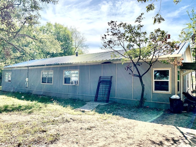 spare room with hardwood / wood-style floors, wood walls, and a wealth of natural light