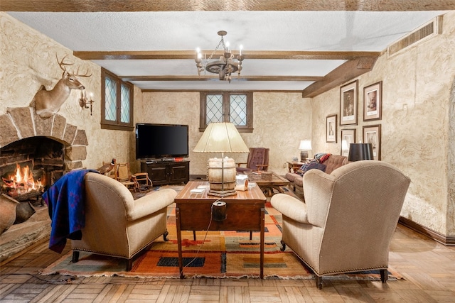 living room featuring beam ceiling, plenty of natural light, a textured ceiling, a stone fireplace, and a chandelier