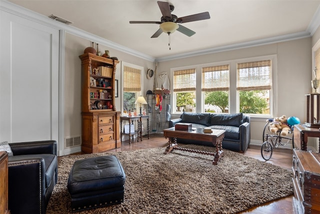 living room with ceiling fan, crown molding, and wood-type flooring