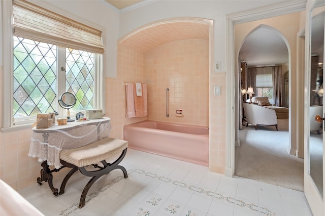 bathroom featuring a tub, tile flooring, and a wealth of natural light