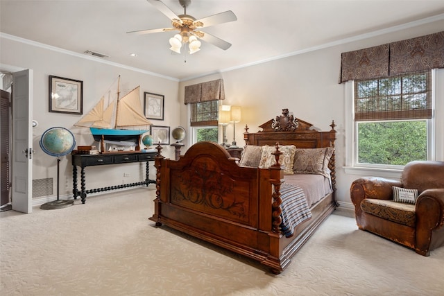 carpeted bedroom with ceiling fan and ornamental molding