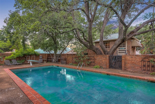 view of pool featuring a diving board