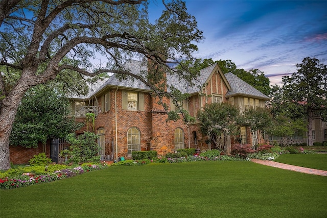 tudor-style house with a yard