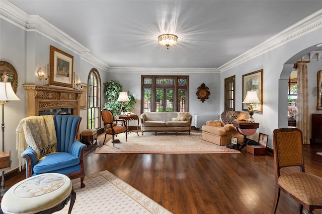 living room featuring hardwood / wood-style floors, crown molding, and a wealth of natural light