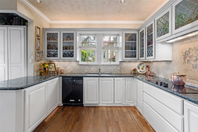 bar with hardwood / wood-style flooring, dark stone countertops, sink, black appliances, and ornamental molding