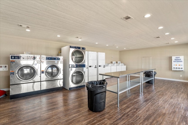 clothes washing area with washing machine and clothes dryer, dark wood-type flooring, and stacked washer / drying machine