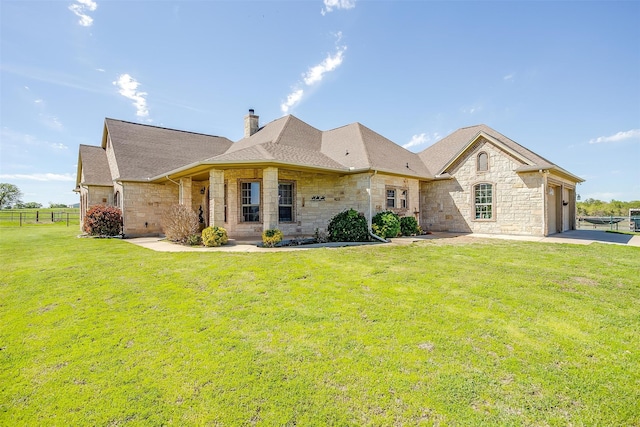 view of front of house with a garage and a front lawn