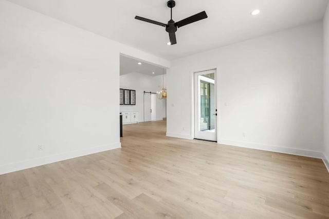 spare room with light hardwood / wood-style floors and ceiling fan