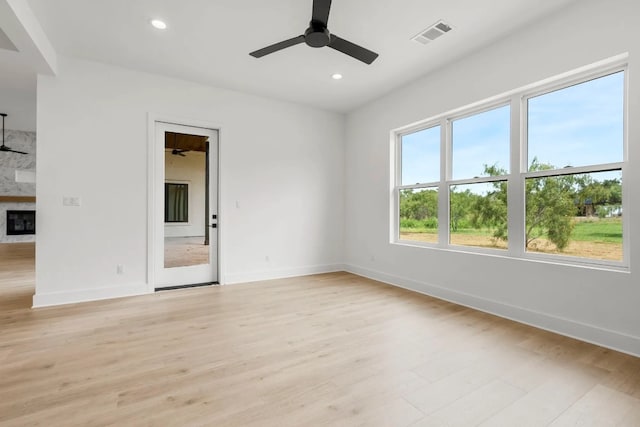 spare room with light hardwood / wood-style floors and ceiling fan