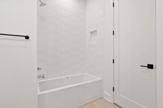 bathroom featuring shower / bathing tub combination and tile flooring