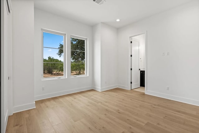 unfurnished room with light wood-type flooring