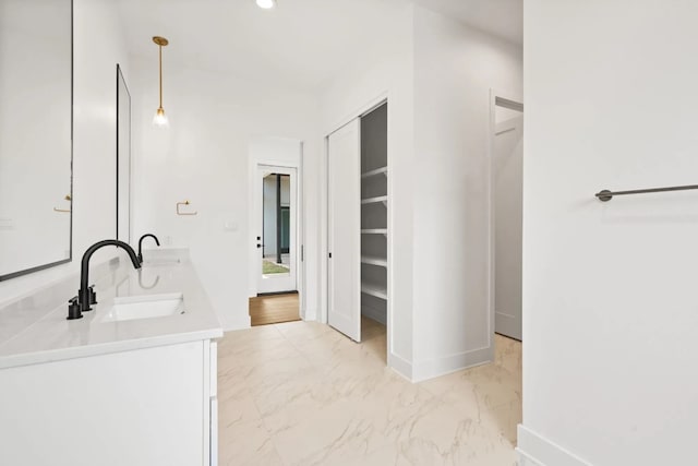 bathroom with dual vanity and tile flooring