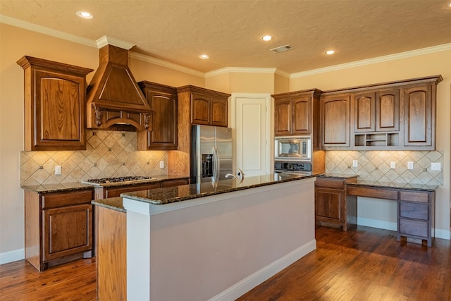 kitchen featuring a center island with sink, stainless steel appliances, custom range hood, and dark hardwood / wood-style flooring