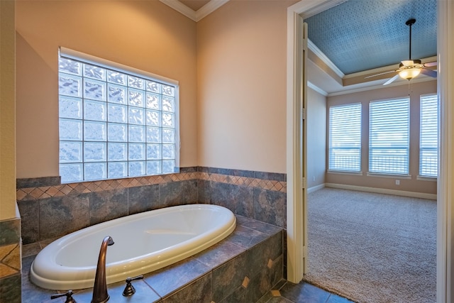 bathroom with a relaxing tiled bath, ceiling fan, and crown molding