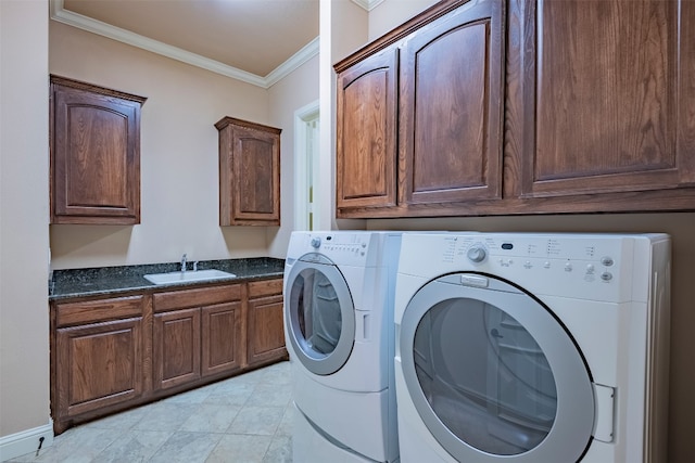 clothes washing area with light tile floors, cabinets, crown molding, independent washer and dryer, and sink