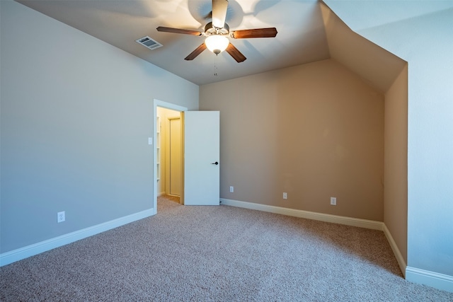 interior space with light carpet, ceiling fan, and vaulted ceiling