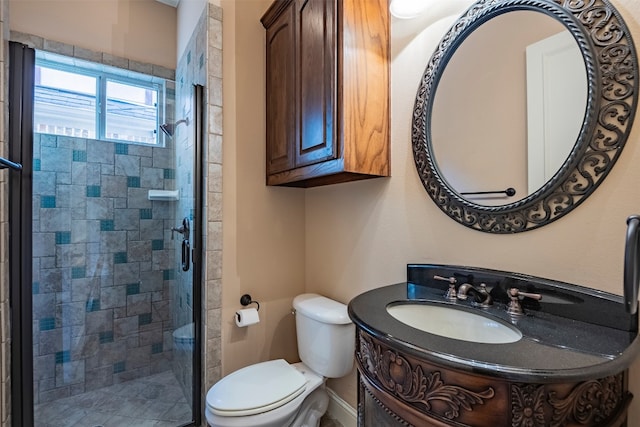 bathroom with a shower with shower door, toilet, and vanity with extensive cabinet space