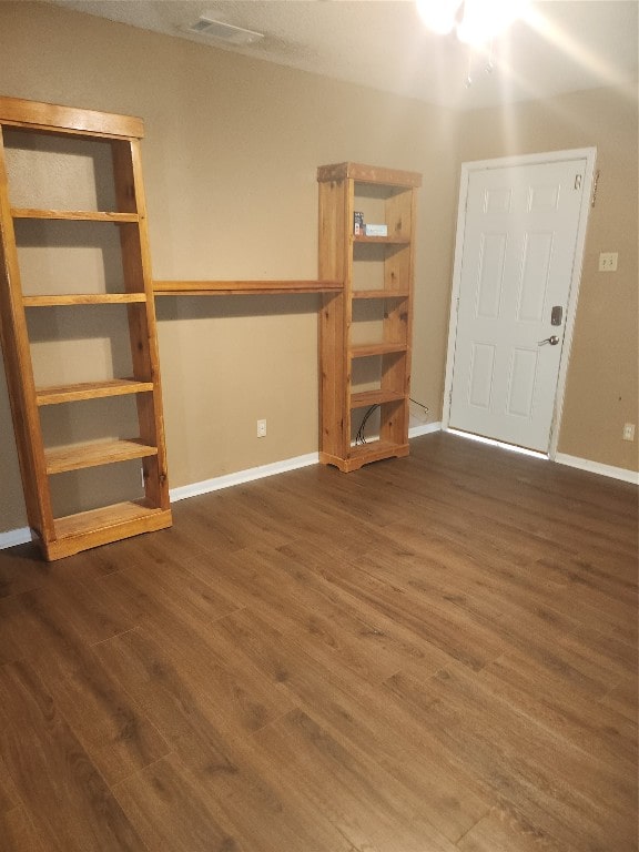 spare room featuring dark wood-type flooring