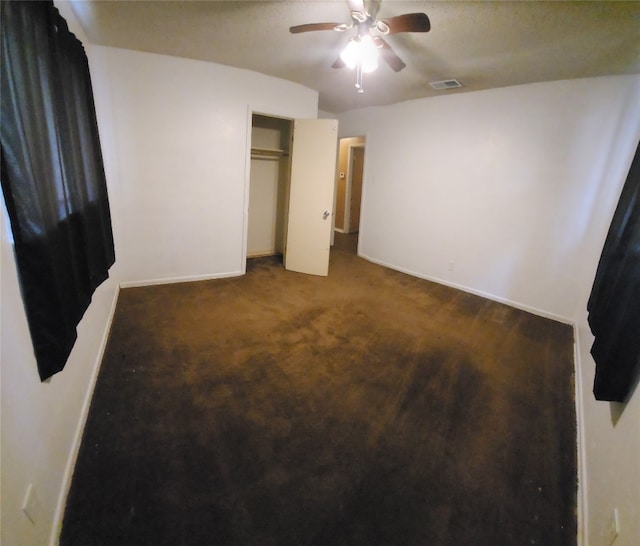 bedroom with ceiling fan, a closet, and dark carpet